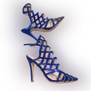 Light worn royal blue glittery heels in a size 7